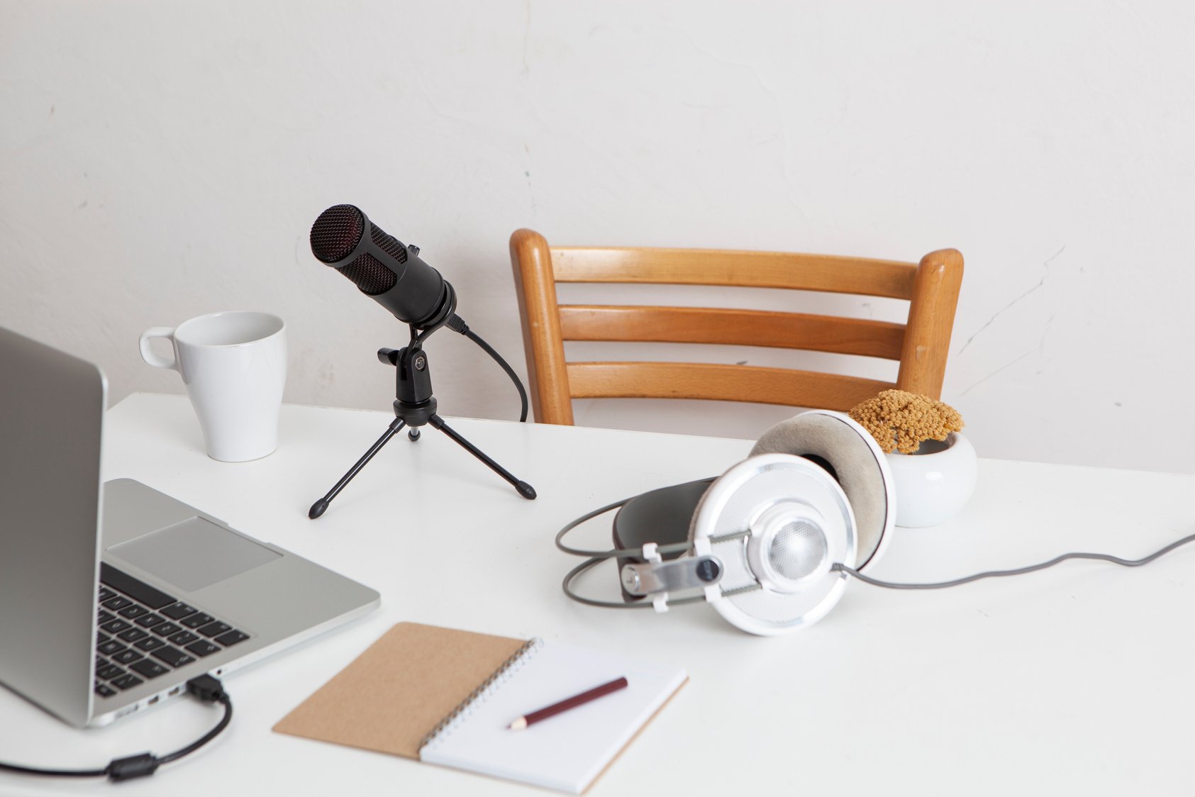 Headphones, Microphone, Laptop and Notebook on White Desk